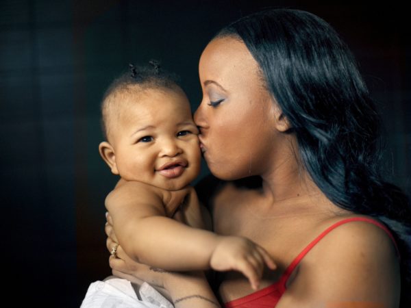 Woman kissing her baby on the cheek